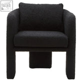 Black boucle curved armchair with plush fuzzy upholstery and modern blocky design perfect for cozy seating
