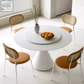 White ozzie round dining table with central rotating tray and sleek pedestal base perfect for round dining spaces