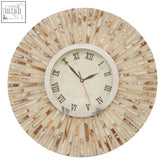 A palu natural shell wall clock with a sunburst design of beige and cream wooden slats and black roman numerals