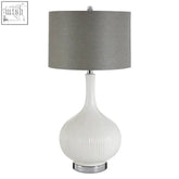 Pandora white table lamp with a ribbed ceramic base and sleek gray fabric shade perfect for cozy lighting