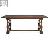 Rustic rectangular dining table with turned legs made of oak wood in rich brown finish for dining use