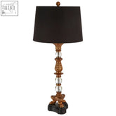 Pavo table lamp with gold-toned bronze tones, ornate carved base, crystal bead accents, and black drum shade