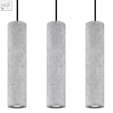 Three gray concrete cylindrical pendant lamps with black cords designed for gu10 light bulbs in industrial style