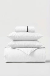 White cotton percale essentials bedding set with subtle black woven band on rolled pillowcase