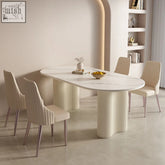 Cream-colored marble peru dining table with oval top and ribbed cylindrical legs perfect for dining table use