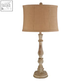 Antique white distressed wood petra table lamp with beige textured fabric shade for cozy lighting