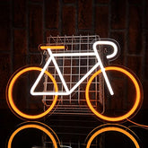 A white neon usb powered glowing bicycle led sign with orange wheels and an illuminated wire basket for wall decor