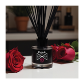 Black glass pink oud single diffuser bottle with dank mer branding filled with dark fragrance oil and black reed sticks