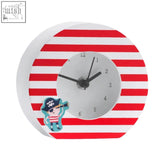 Pirate table clock with white face black hands white and red striped pirate theme and cartoon character on the side