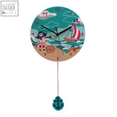 A pirate wall clock with black hands red numbers teal ocean and sandy beach design and a turquoise anchor pendulum