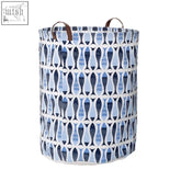 Blue and white patterned fabric pisces laundry bag with brown leather handles and blue fish pattern design