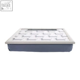 White lap tray with grid of silver dachshund silhouettes and navy blue padded base for dachshund lap use