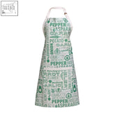 White apron with green vegetable print and words like pepper asparagus and potato in various fonts porter green apron