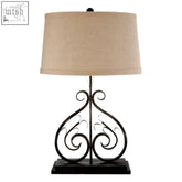 Black wrought iron portia table lamp with elegant swirling design and beige linen shade for stylish lighting