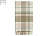 A soft cream-colored merino lambswool throw with subtle plaid in natural rose tones perfect for cozying up