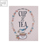 Delicate pink tea wall plaque with blue bird on teacup framed by floral wreaths from pretty things cup design