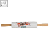 Pretty things rolling pin is a white rolling pin with wooden handles and a pink ribbon design that reads roll with