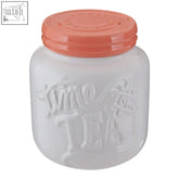 White ceramic pretty things tea canister with coral lid and embossed sweet treat text for stylish storage