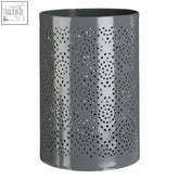 Grey candle holder with punched metal pattern featuring circular perforations for large candle use