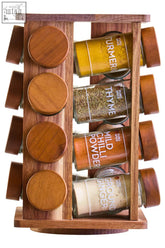 Puro acacia wood revolving spice rack with four glass jars filled with turmeric thyme chili powder and ginger