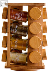 Puro bamboo revolving spice rack with clear glass jars and wooden lids holding mild chili, thyme, turmeric, and ginger