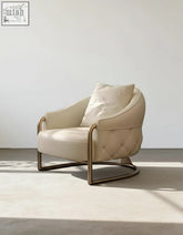 Cream-colored tufted real leather quigley lobby lounge chair with sleek curved brass frame perfect for reception chairs
