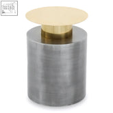 A rabia accent table featuring a sleek cylindrical metallic container with brushed silver body and gold-toned lid