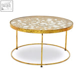 Gold-toned rabia butterfly coffee table with mosaic glass top featuring white and beige stone-like patterns