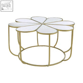 Gold-toned metal petal coffee table with flower-shaped design and mirrored top perfect for stylish living rooms