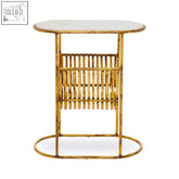 Gold finished metal rabia table with white marble top and vertical slat design featuring a built in magazine rack