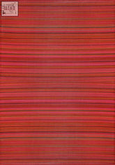 A woven rainbow outdoor rug terra with horizontal stripes in shades of red pink and orange perfect for outdoor use