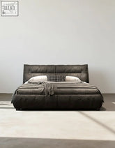 Dark gray upholstered king size bed with tufted headboard and matching platform base with storage
