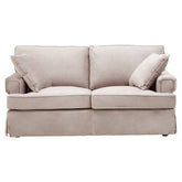 Beige upholstered ralph two seat mink velvet sofa with rolled arms and matching throw pillows in mink velvet