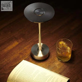 Modern minimalist rechargeable table lamp with a sleek black top and brushed brass aluminium base