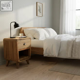Light brown teak wood nightstand with single drawer and tapered legs made from upcycled teak wood from retired fishing boats