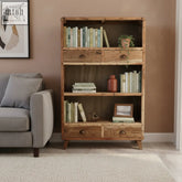 Rustic teak wood bookshelf with two drawers on top and bottom shelves in natural finish with metal handles