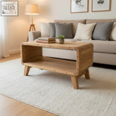 Light-colored teak wood coffee table with rustic minimalist design and tapered legs 81x49x41cm