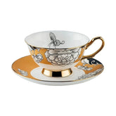 Elegant regal bloom bone china teacup and saucer with gold trim and black white floral butterfly design