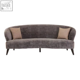 Reine 3 seat grey velvet sofa with sleek curved design beige pillows and slender black legs velvet sofa