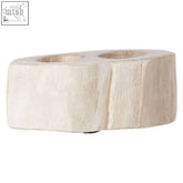 Cream-colored textured petrified wood double candle holder with two circular indentations for candles