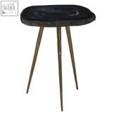 Relic side table with black agate stone top and brass finish legs featuring a petrified wood style look