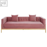 A plush rena 3-seat pink sofa with velvet upholstery, tufted backrest, armrests, and gold-tone metal legs