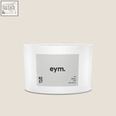 White cylindrical three wick candle in minimalist container with gray eym label the sleepy one natural scent rest