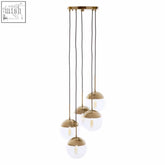 Gold finish five pendant lights with gold toned metal and five spherical glass globes with exposed filament bulbs