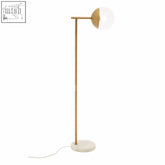 Gold finish metal floor lamp with spherical glass shade and white marble base in revive gold finish metal floor style