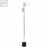 Modern chrome finished metal floor lamp with silver finish metal base and two clear glass globe shades