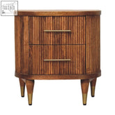 A mid-century modern nightstand in solid mango wood with an amber oak finish and two ribbed-front drawers with brass handles