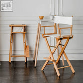 A light wood rivas foldable director chair with white canvas seat and backrest perfect for casual seating