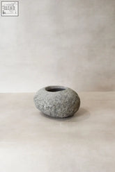 A smooth rounded gray river stone planter pot no8 with natural speckles and a slightly rough texture