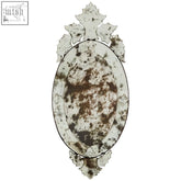 Antique-style oval riza wall mirror with distressed silver brown patina and decorative crown leaf embellishments